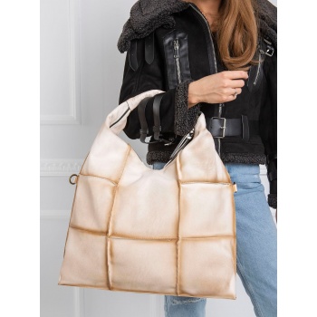 a very large beige bag